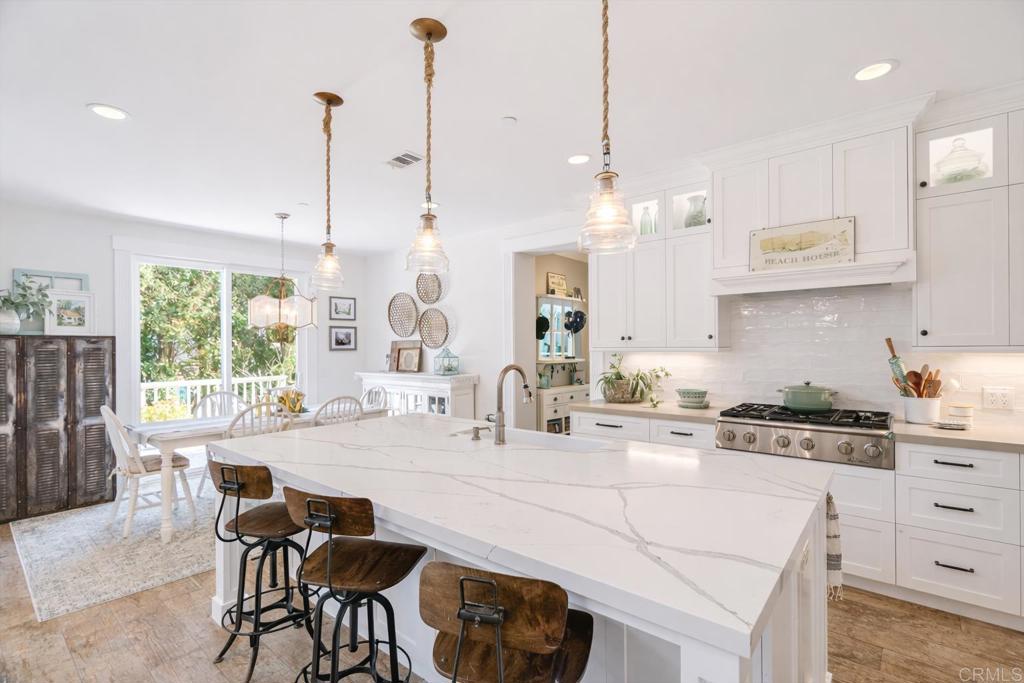 162 Jupiter Street Encinitas, CA 92024 - Photo 8 of 31 a kitchen with stainless steel appliances kitchen island granite countertop a stove a sink and a chandelier