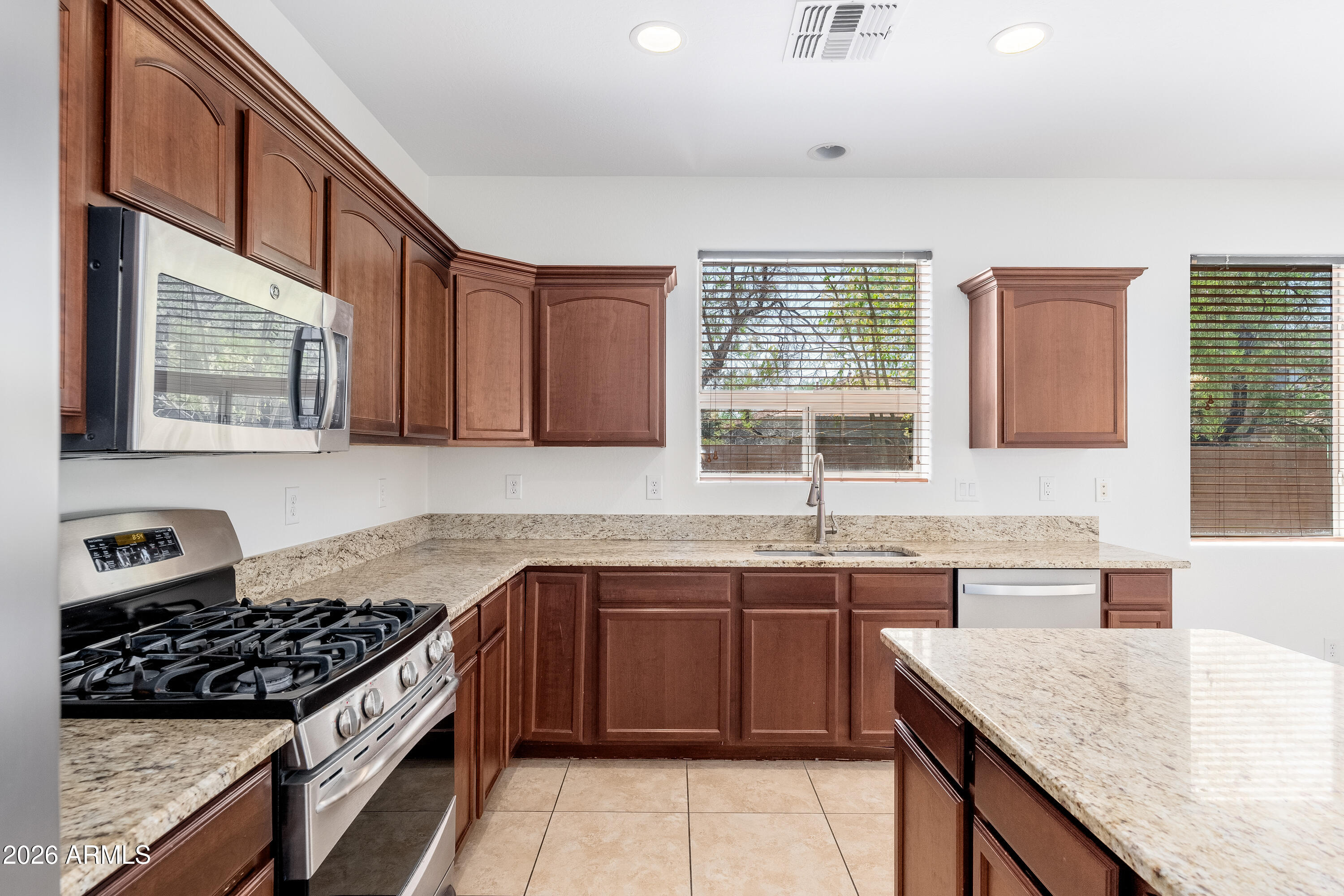 4317 East Folgers Road Phoenix, AZ 85050 - Photo 11 of 40 a kitchen with a sink stove top oven and cabinets