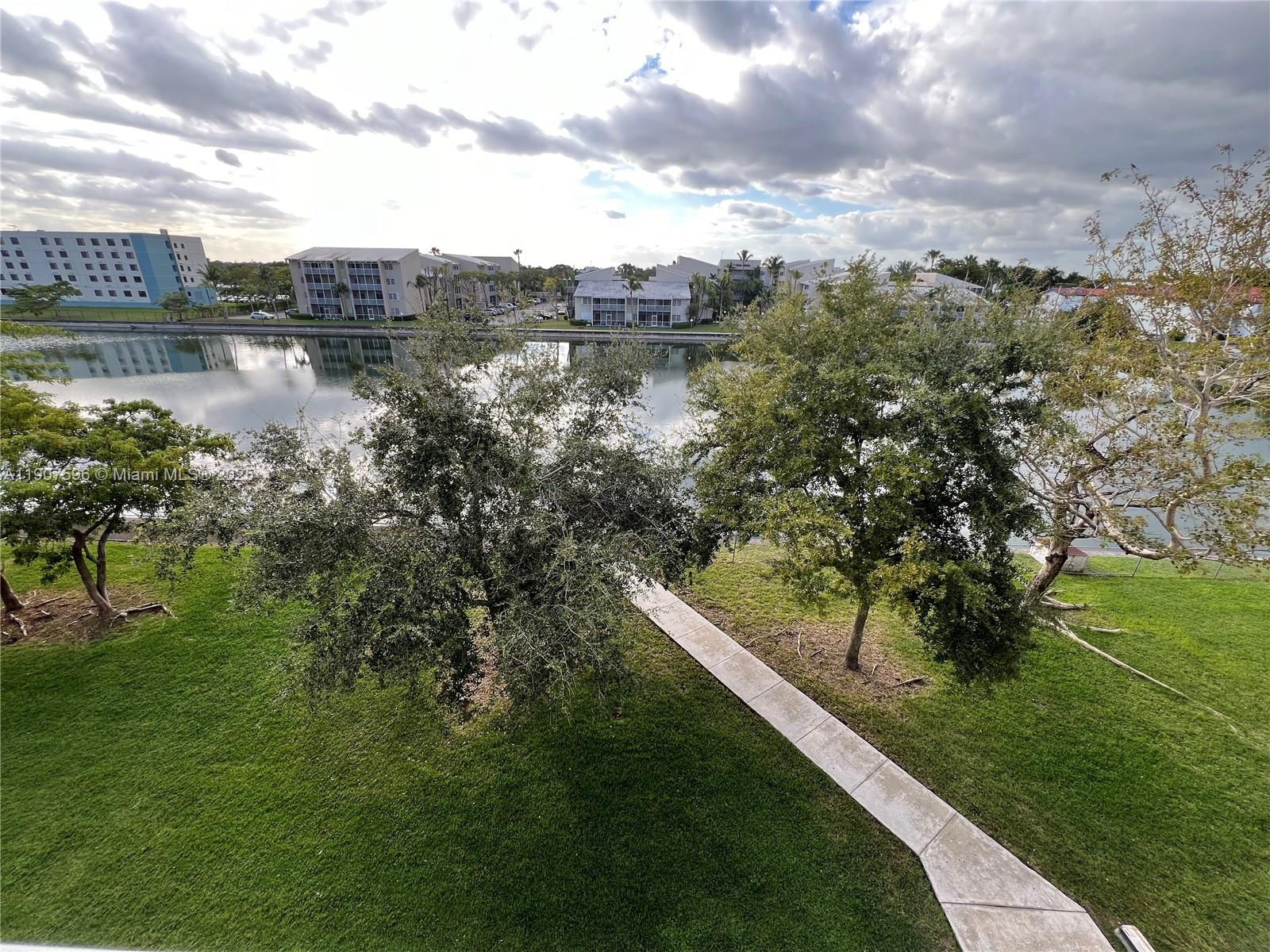 8260 Southwest 210th Street, Unit 302 Cutler Bay, FL 33189 - Photo 11 of 42 a view of a lake with a yard