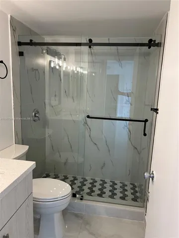 a bathroom with a sink and mirror with toilet