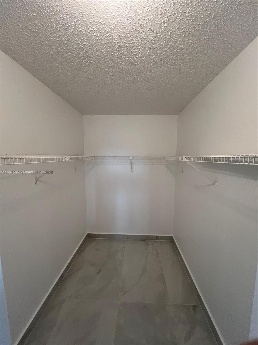 8260 Southwest 210th Street, Unit 302 Cutler Bay, FL 33189 - Photo 21 of 42 a view of a room with racks on the wall