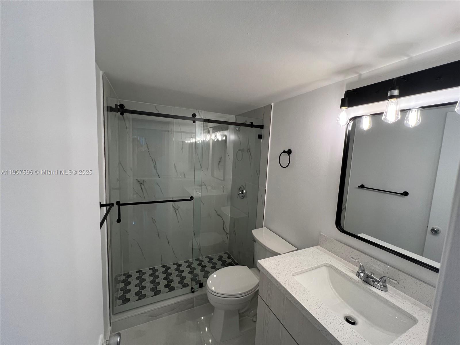 8260 Southwest 210th Street, Unit 302 Cutler Bay, FL 33189 - Photo 6 of 42 a bathroom with a sink toilet and shower