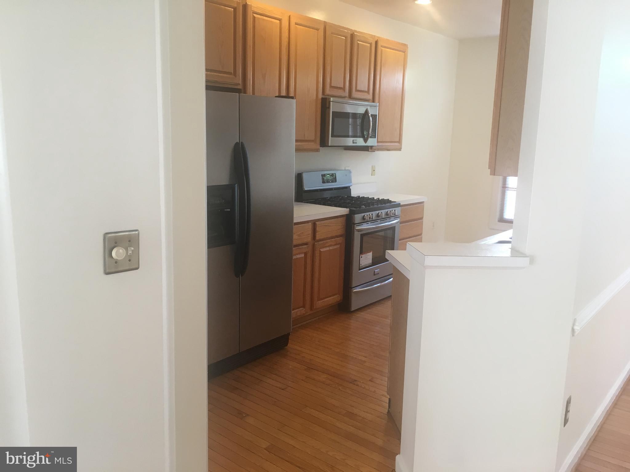 5801 Summers Grove Road Alexandria, VA 22304 - Photo 6 of 27 a kitchen with stainless steel appliances granite countertop a refrigerator and a stove