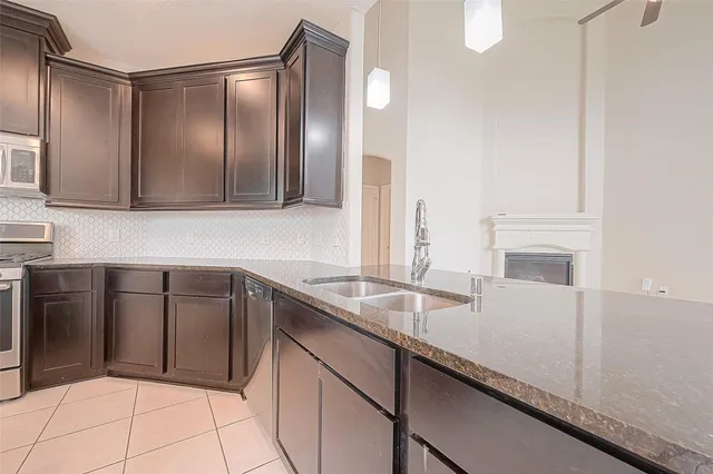 a kitchen with stainless steel appliances granite countertop a sink and cabinets
