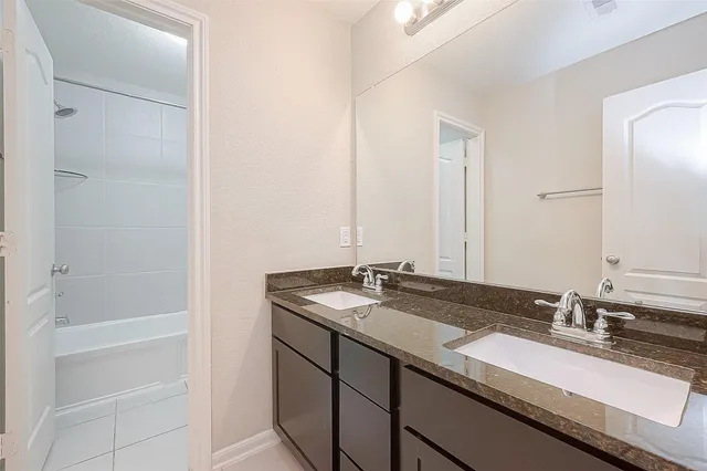 a white bath tub sitting next to a white toilet and sink