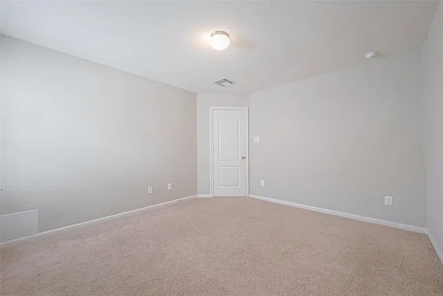 an empty room with a empty space and windows