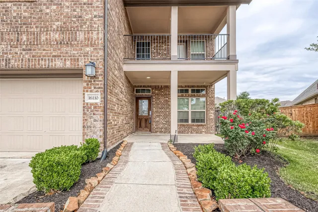 front view of a brick house with a large windows