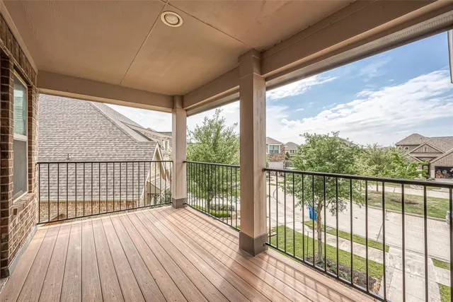 a view of a balcony with wooden floor