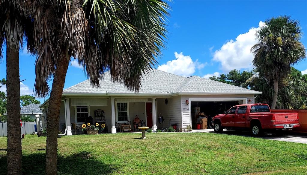 26262 Brooks Road Punta Gorda, FL 33955 - Photo 1 of 1 a view of a car parked in front of house with a yard