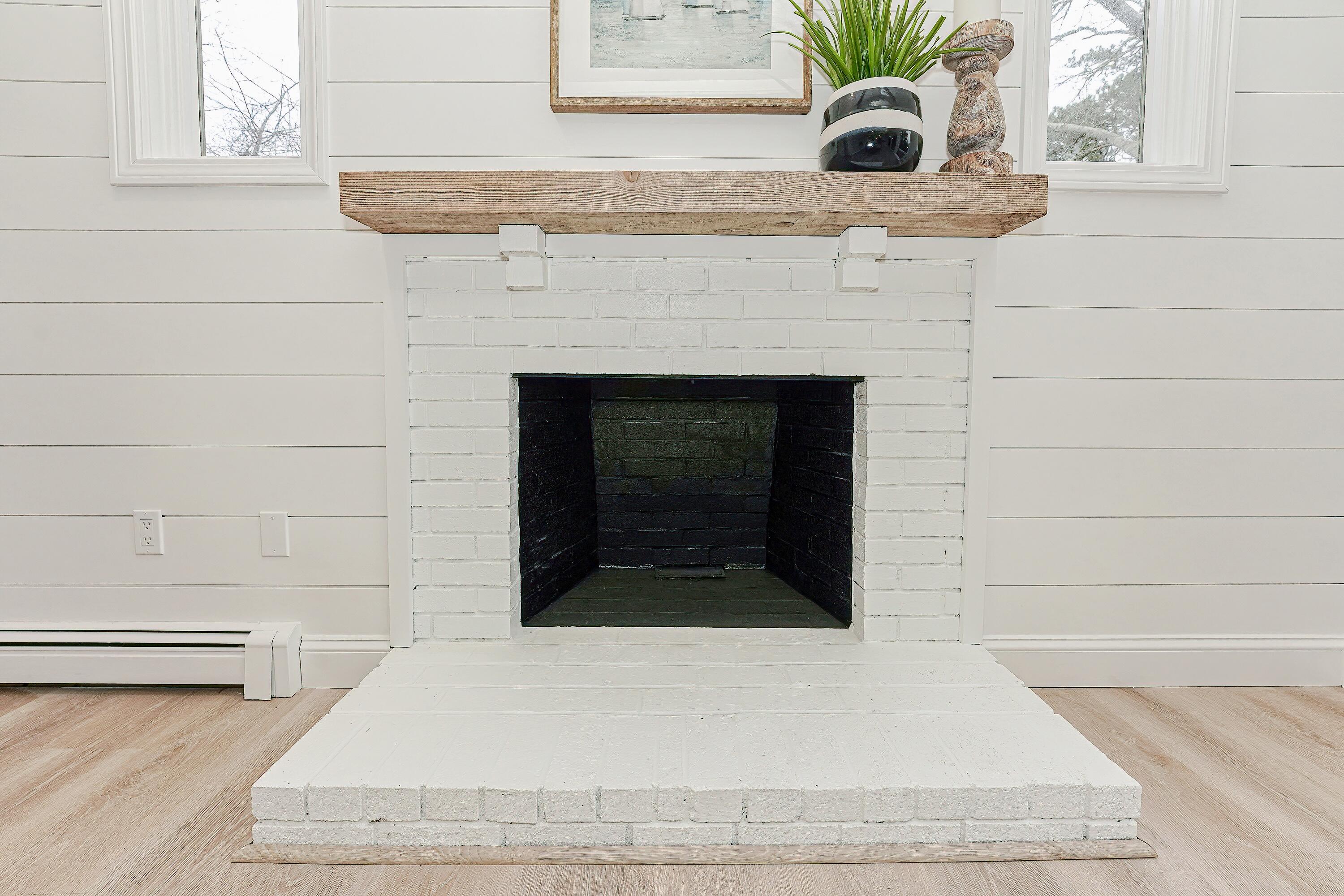 164 Katherine Road Centerville, MA 02632 - Photo 11 of 47 a living room with a fireplace and potted plant