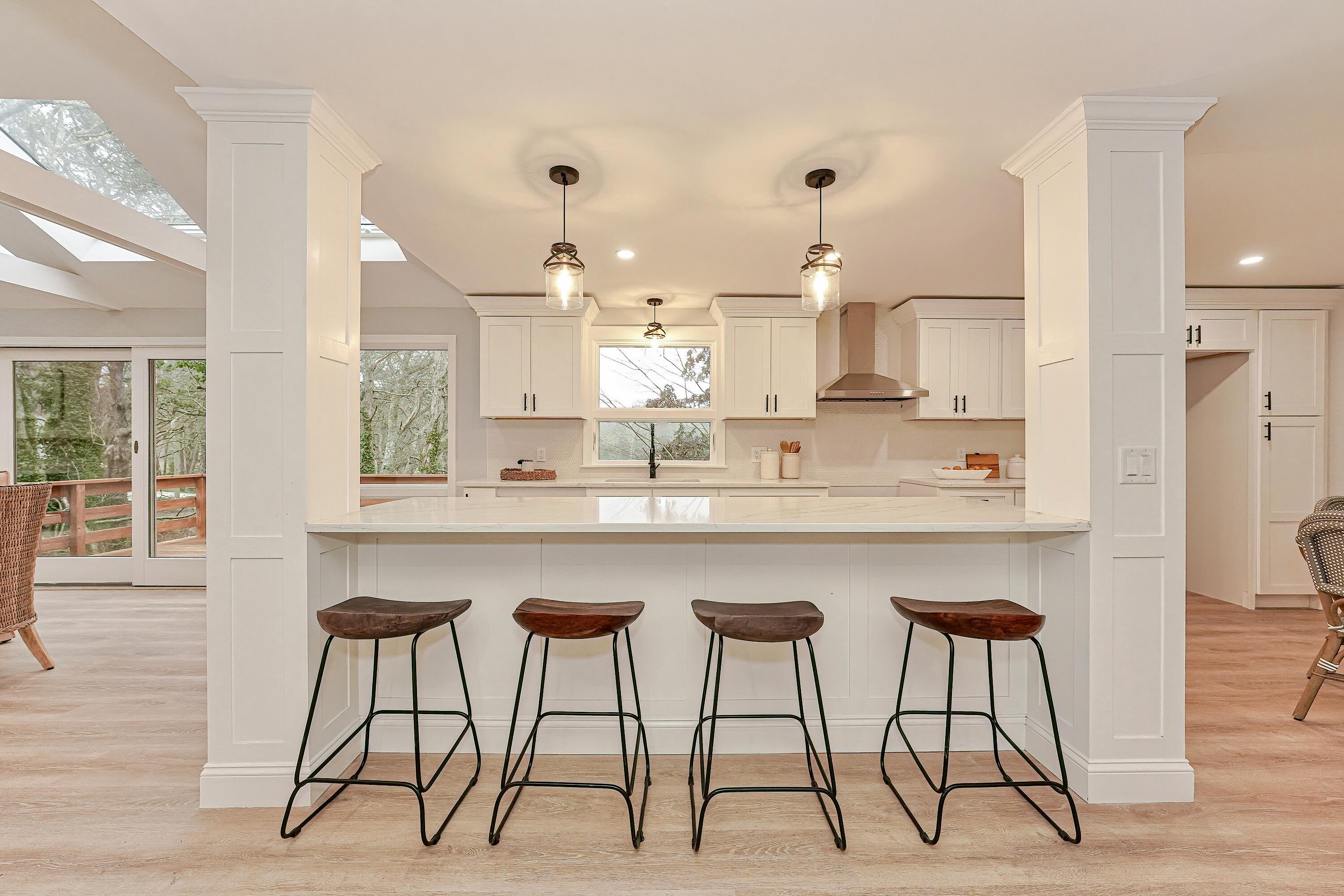164 Katherine Road Centerville, MA 02632 - Photo 14 of 47 a kitchen with stainless steel appliances kitchen island a large window and cabinets