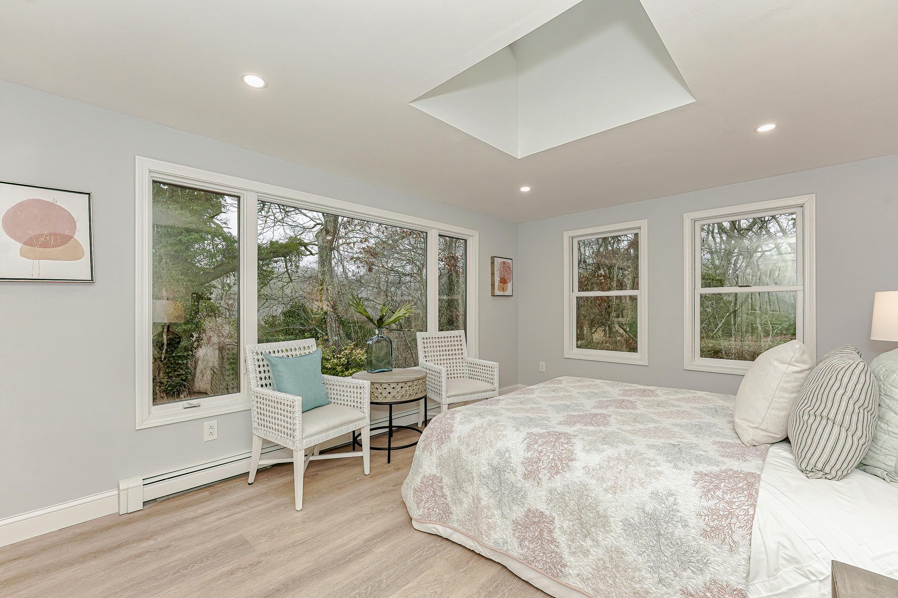 164 Katherine Road Centerville, MA 02632 - Photo 20 of 47 a large bedroom with a bed and wooden floor