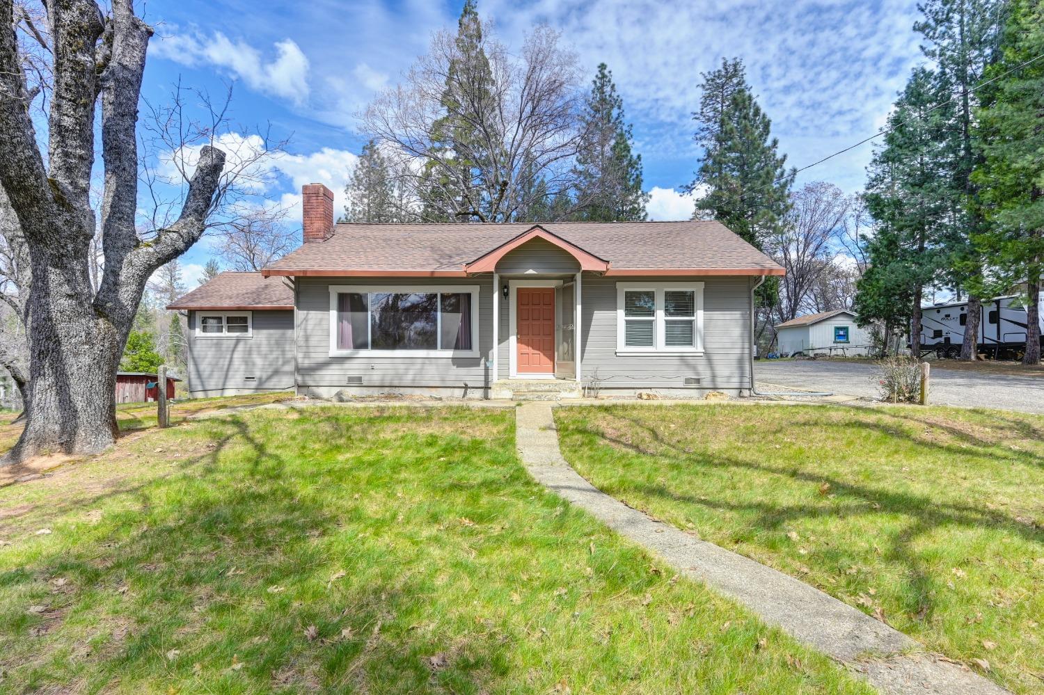 22764 West Point Pioneer Road West Point, CA 95255 - Photo 1 of 1 a front view of a house with swimming pool and large trees