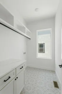 a room with a white cabinets and a window