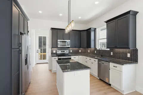 a kitchen with stainless steel appliances a sink stove and refrigerator