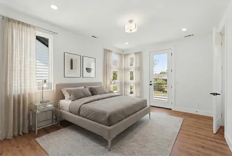 a bedroom with a large bed and a window