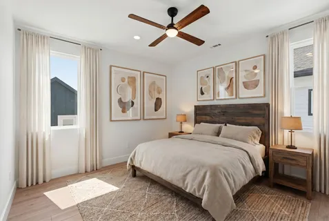 a bedroom with a large bed a lamp and a chandelier