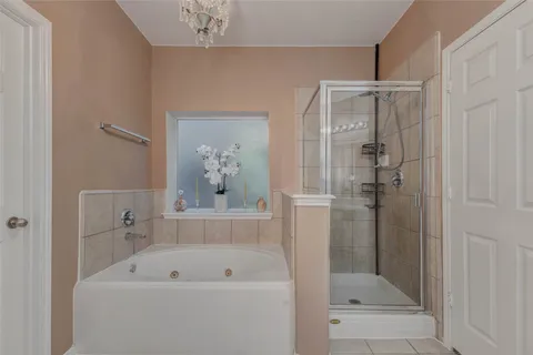 a bathroom with a tub a sink and a mirror