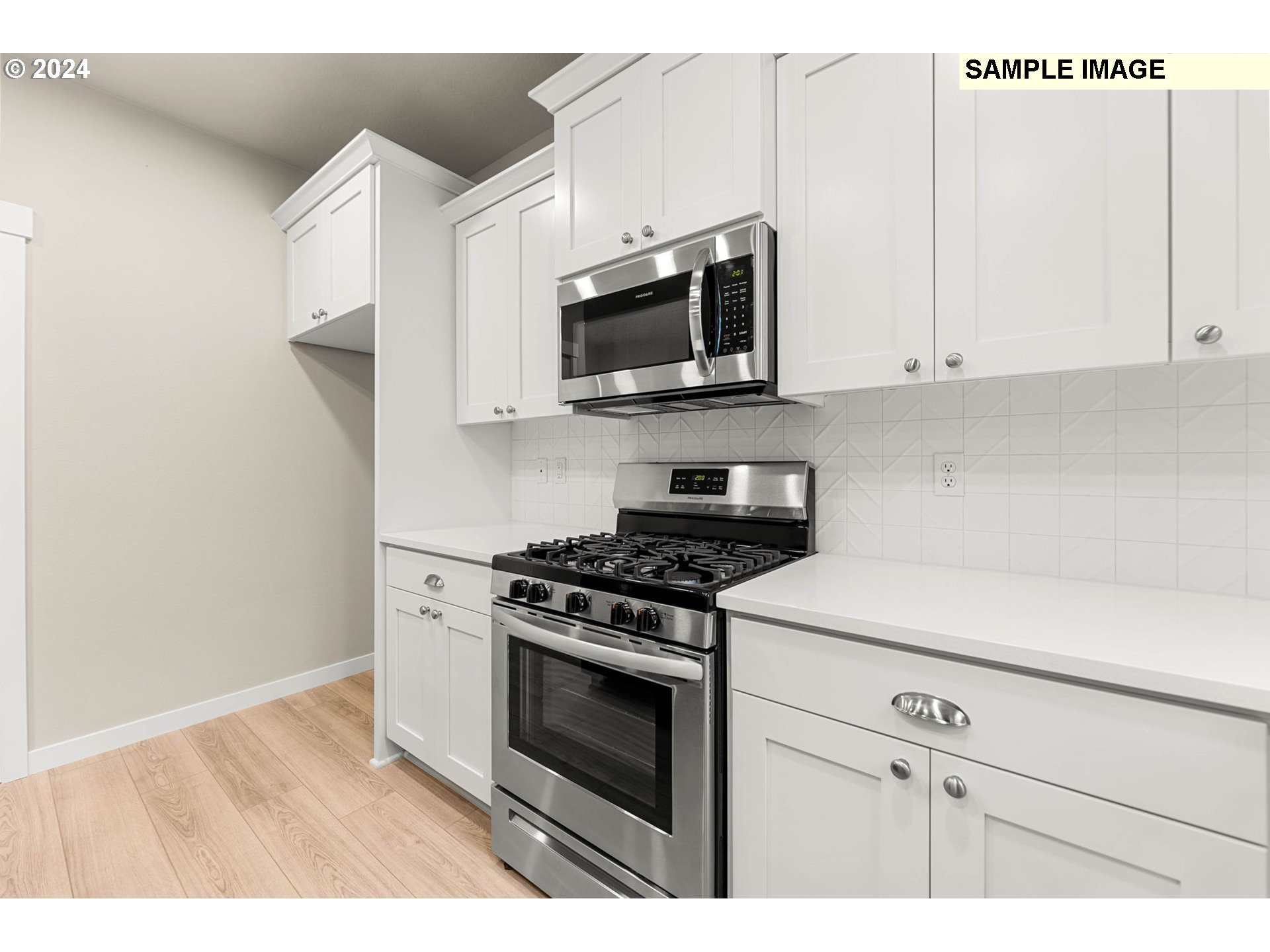 3135 South Nectarine Street Cornelius, OR 97113 - Photo 16 of 41 a kitchen with stainless steel appliances white cabinets and a stove a oven with white countertops