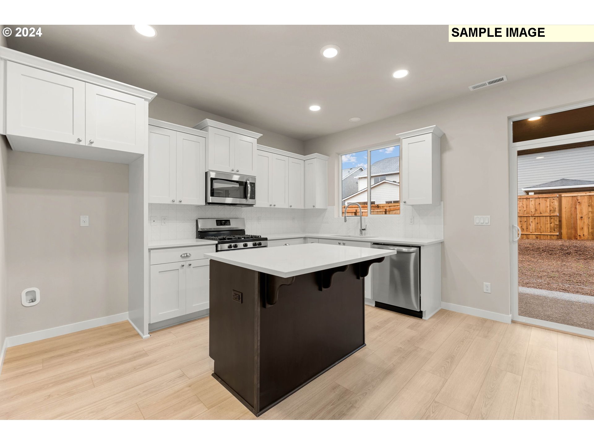 3135 South Nectarine Street Cornelius, OR 97113 - Photo 10 of 41 a kitchen with granite countertop a stove top oven and cabinets