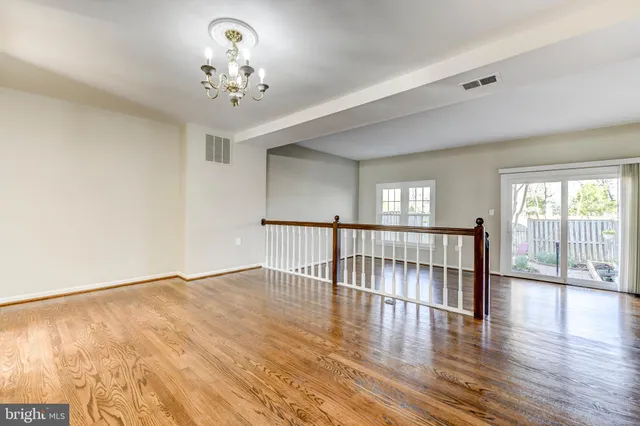 a view of a livingroom with wooden floor and a large window