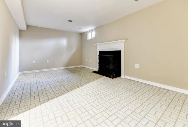 a view of an empty room with a fireplace