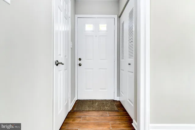 a view of a hallway with wooden floor