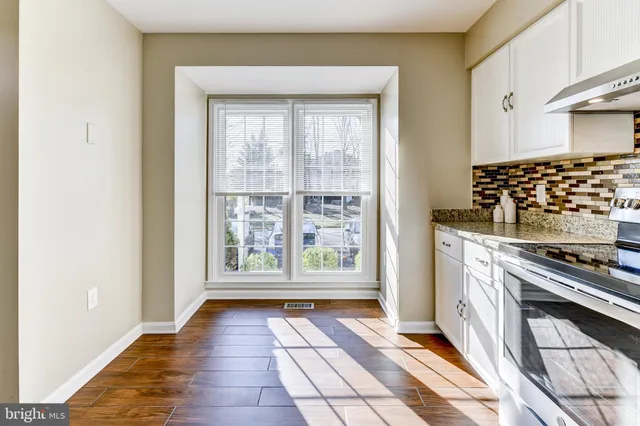a view of a kitchen with a stove top oven