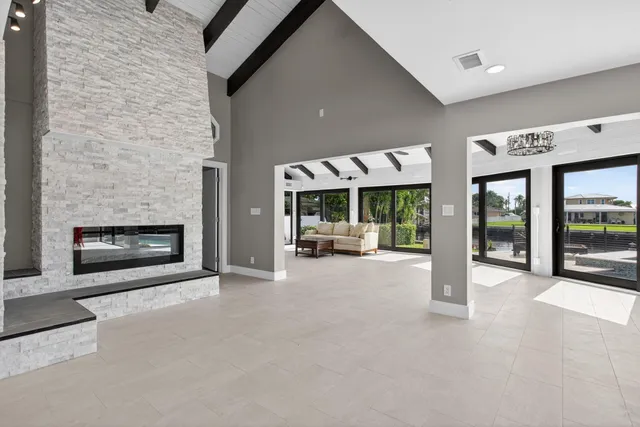 a living room with a large window and a table