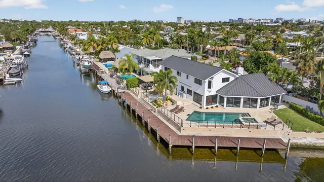 a view of a ocean with boats and trees in the background