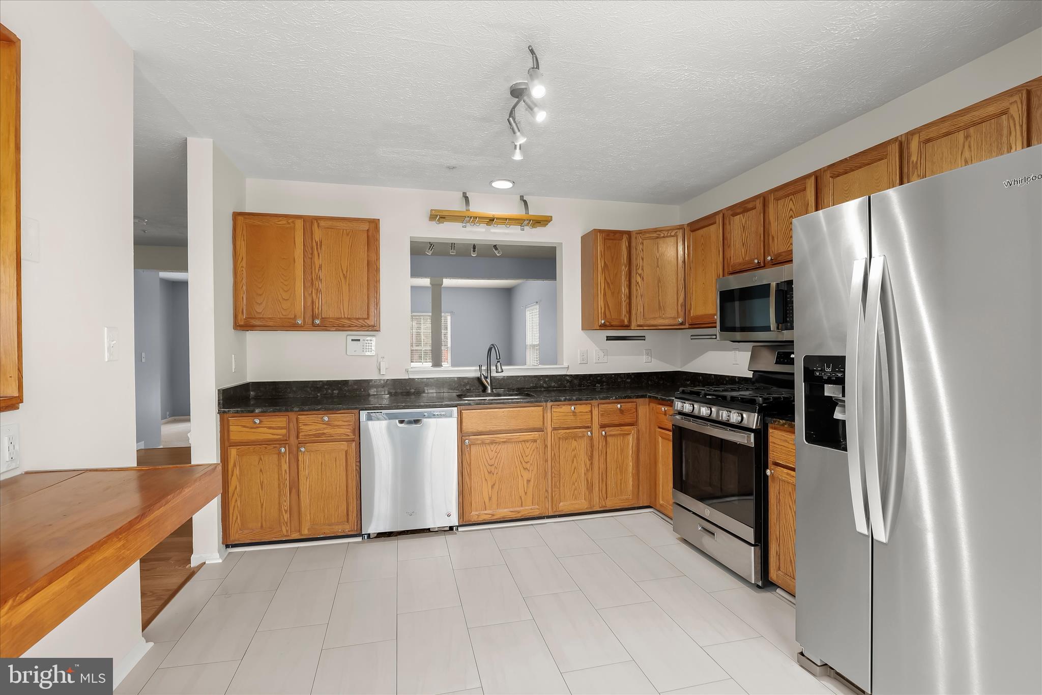 2567 Windy Oak Court Crofton, MD 21114 - Photo 12 of 52 a kitchen with granite countertop stainless steel appliances and wooden cabinets