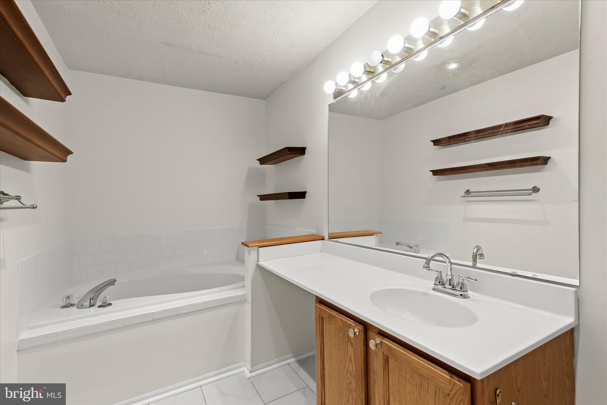 2567 Windy Oak Court Crofton, MD 21114 - Photo 18 of 52 a bathroom with a sink a bathtub and a mirror