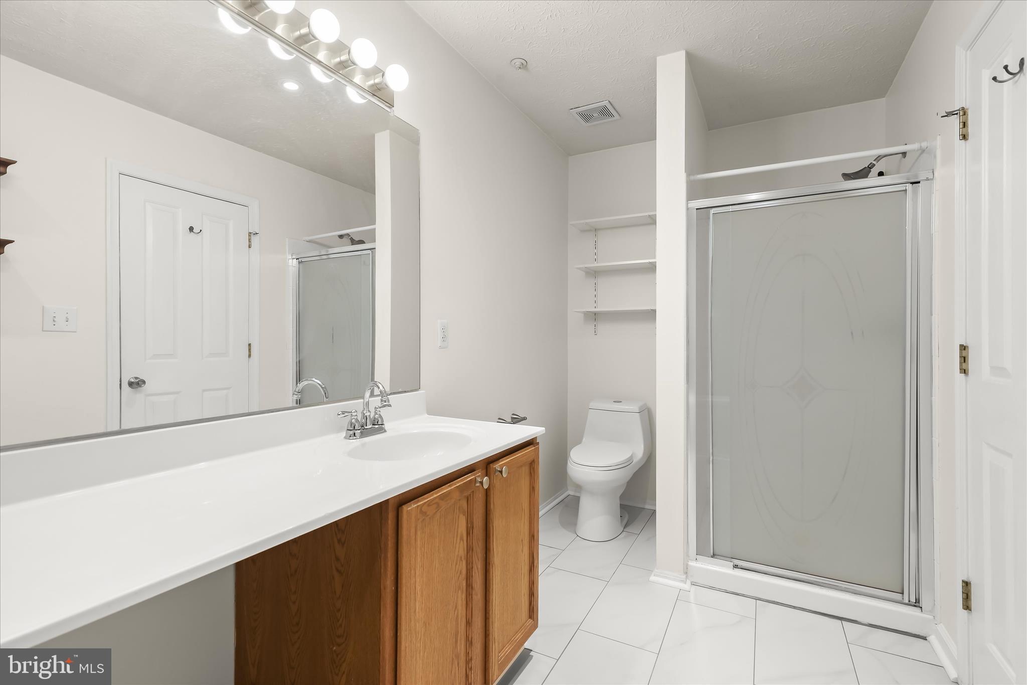 2567 Windy Oak Court Crofton, MD 21114 - Photo 20 of 52 a bathroom with a sink a toilet and shower