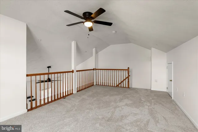 a view of a hallway with a ceiling fan