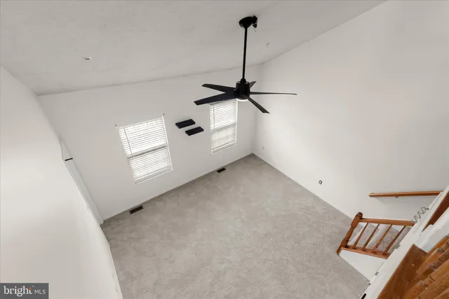 a view of a room with window and a ceiling fan