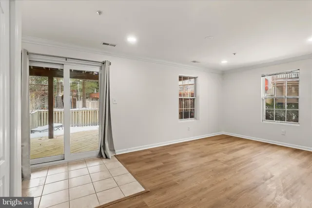 a view of an empty room with glass door