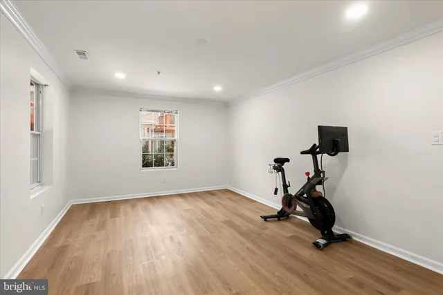 a view of a room with gym equipment and a window