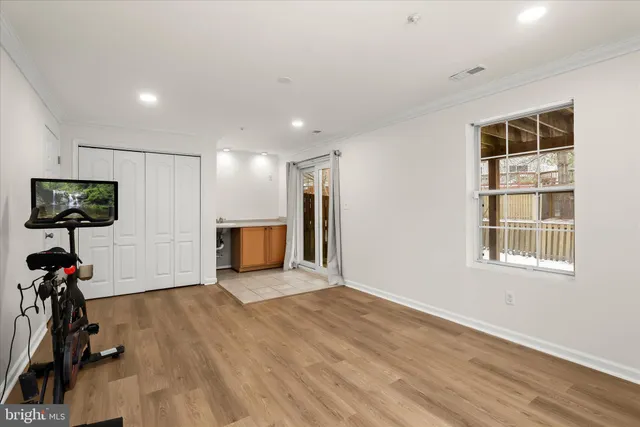 a view of a livingroom with wooden floor and a flat screen tv