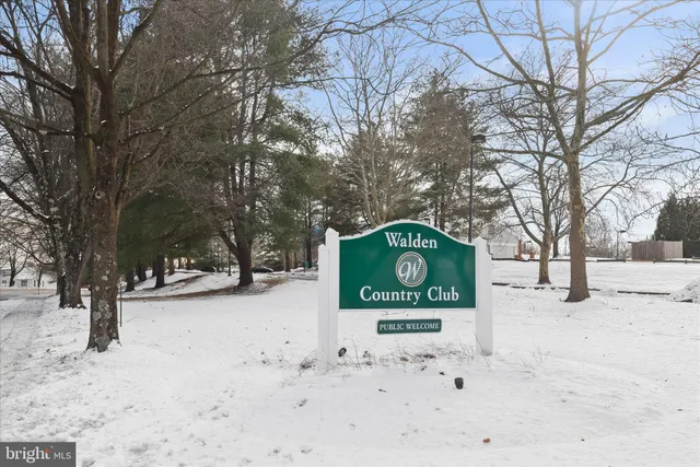 a front view of a building with cars parked