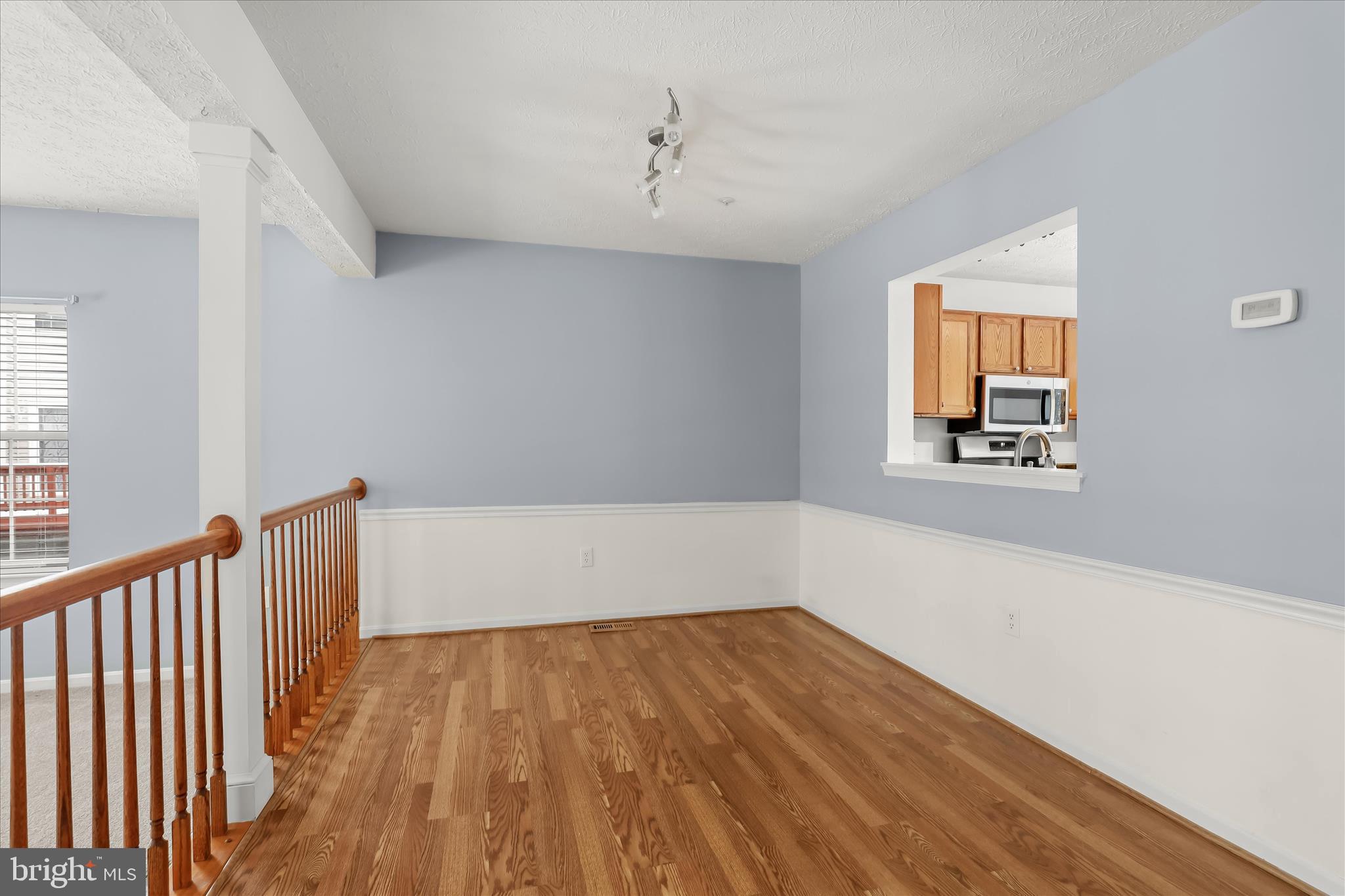 2567 Windy Oak Court Crofton, MD 21114 - Photo 6 of 52 a view of an empty room with wooden floor and a window