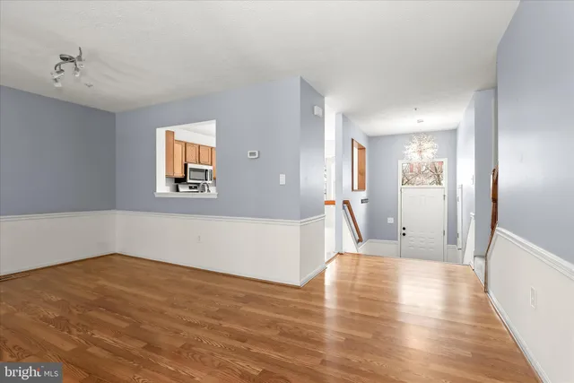 a view of a room with wooden floor and a bathroom