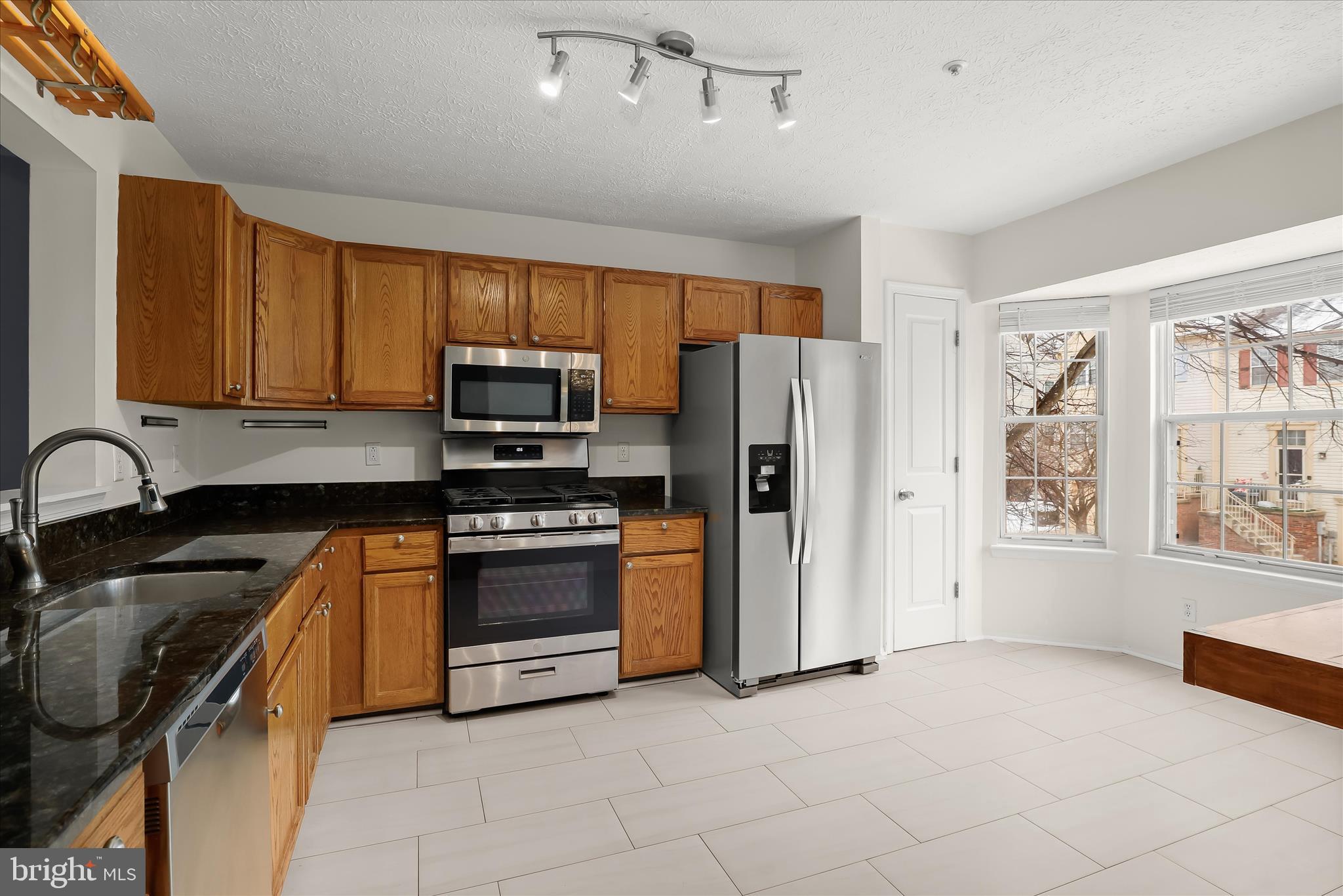 2567 Windy Oak Court Crofton, MD 21114 - Photo 10 of 52 a kitchen with stainless steel appliances granite countertop a stove a sink and a refrigerator