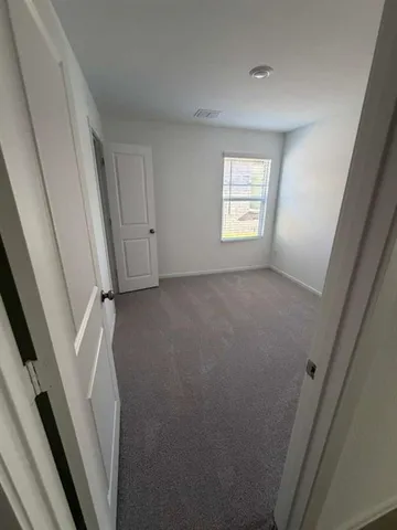 a view of hallway with window and stairs