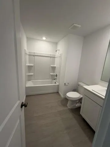 a bathroom with a toilet a sink and shower