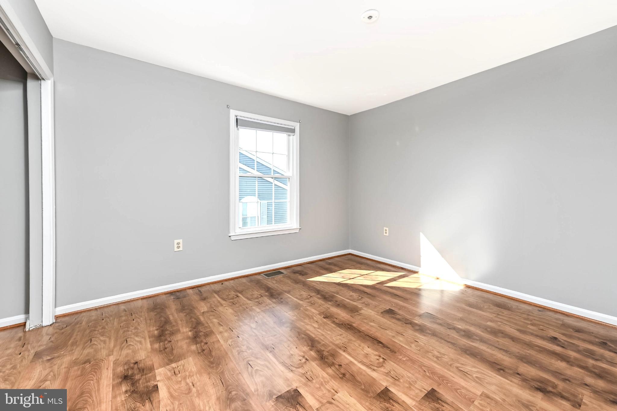 11152 Stagestone Way Manassas, VA 20109 - Photo 18 of 22 an empty room with wooden floor and windows