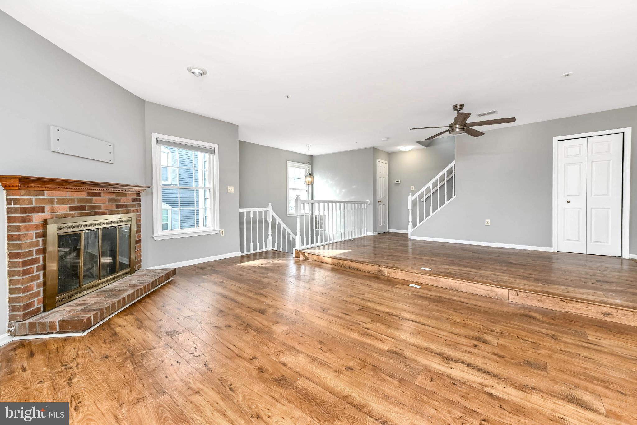 11152 Stagestone Way Manassas, VA 20109 - Photo 3 of 22 a view of empty room with wooden floor and fireplace