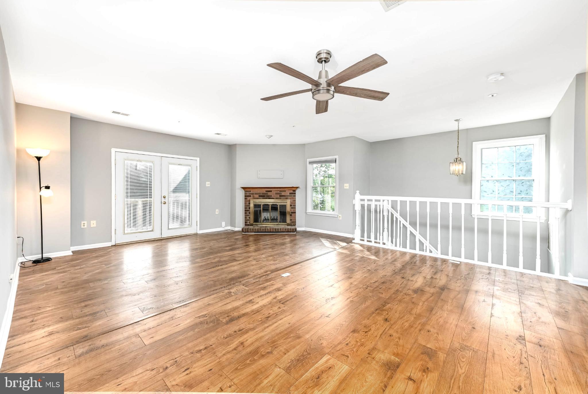 11152 Stagestone Way Manassas, VA 20109 - Photo 4 of 22 a view of empty room with wooden floor and fan