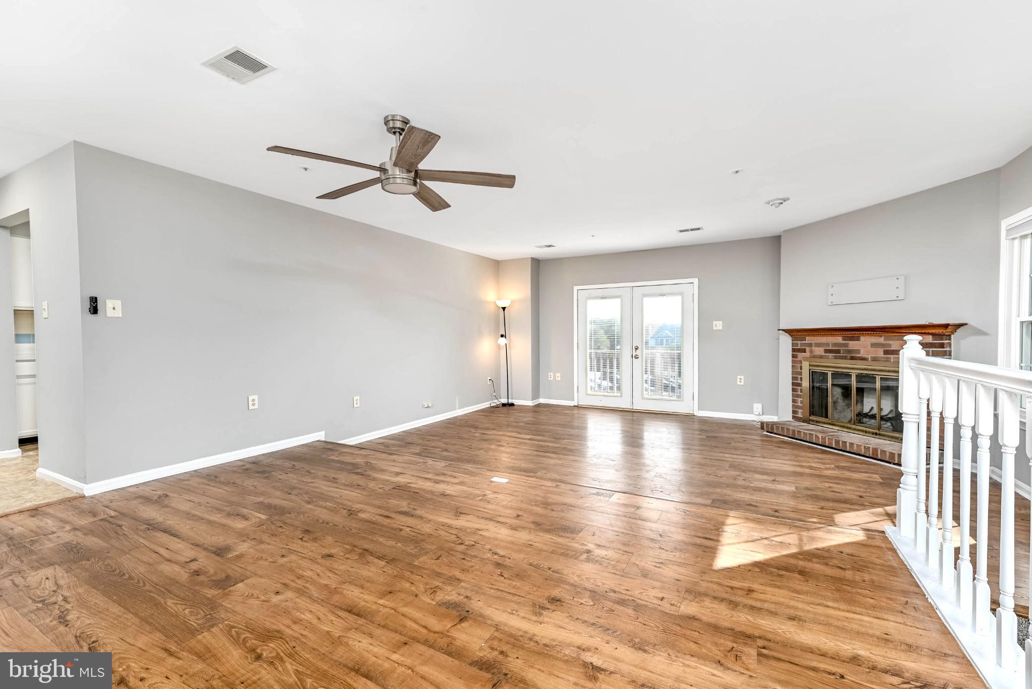 11152 Stagestone Way Manassas, VA 20109 - Photo 5 of 22 a view of empty room with wooden floor and fan