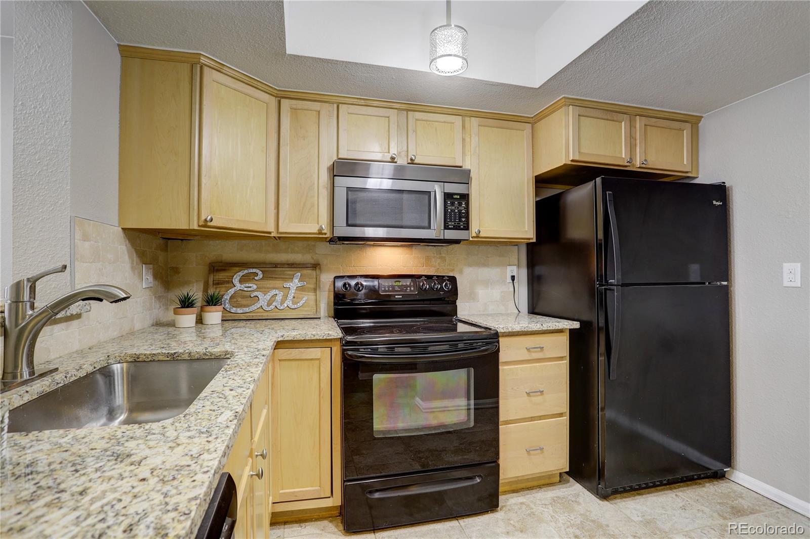 a kitchen with a refrigerator sink and microwave