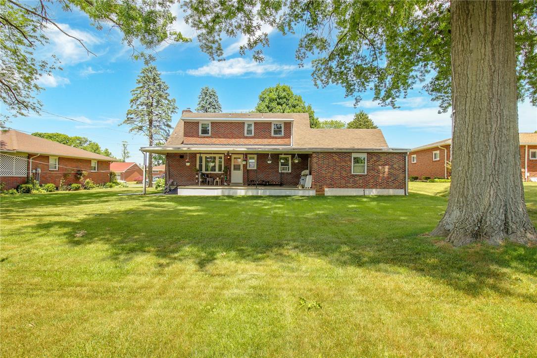1256 Ridge Avenue Whitehall, PA 18052 - Photo 12 of 43 Mature trees shade this charming brick residence, featuring an inviting covered porch and ample backyard space.